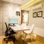 Elegant modern office interior featuring a sleek desk, chairs, and ambient lighting for a sophisticated environment.
